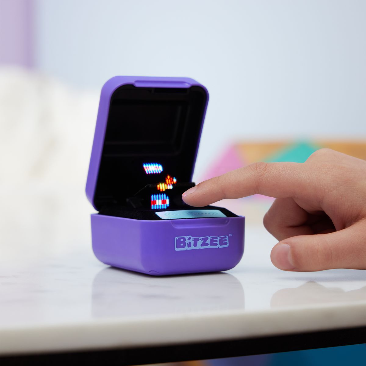 Bitzee interactive digital pet being touched