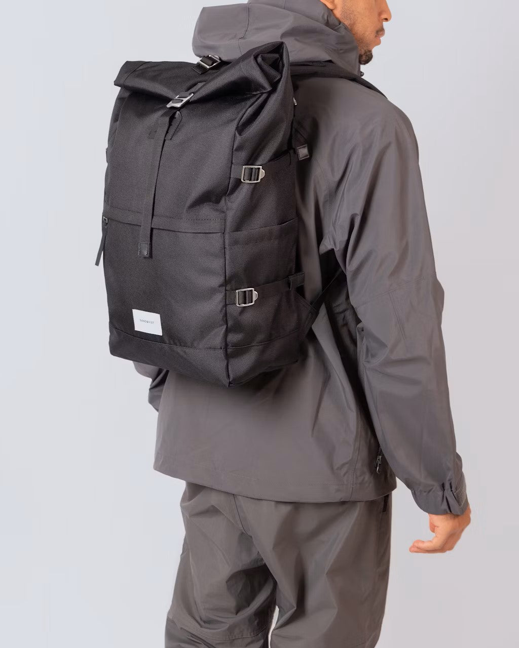 Sandqvist Bernt black rolltop backpack worn on model